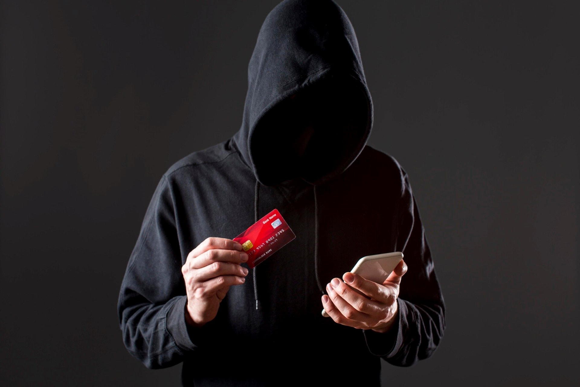 front-view-male-hacker-holding-smartphone-credit-card_23-2148578146.jpg