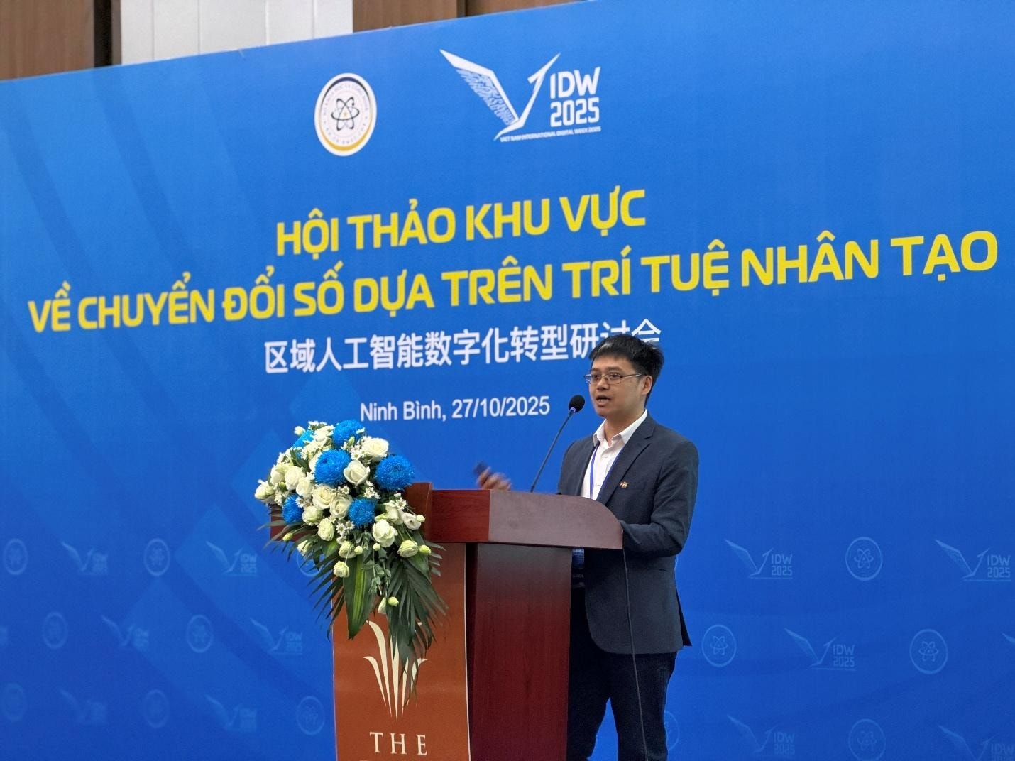 A person standing at a podium with a microphone AI-generated content may be incorrect.